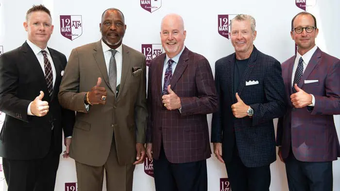 group of men posing with thumbs up