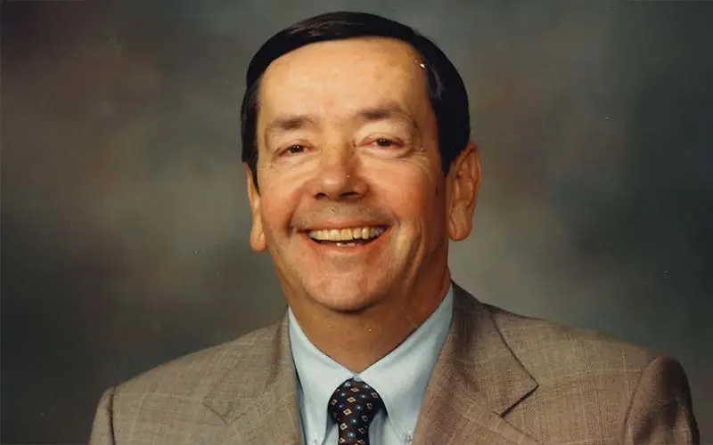 a man in a suit smiling