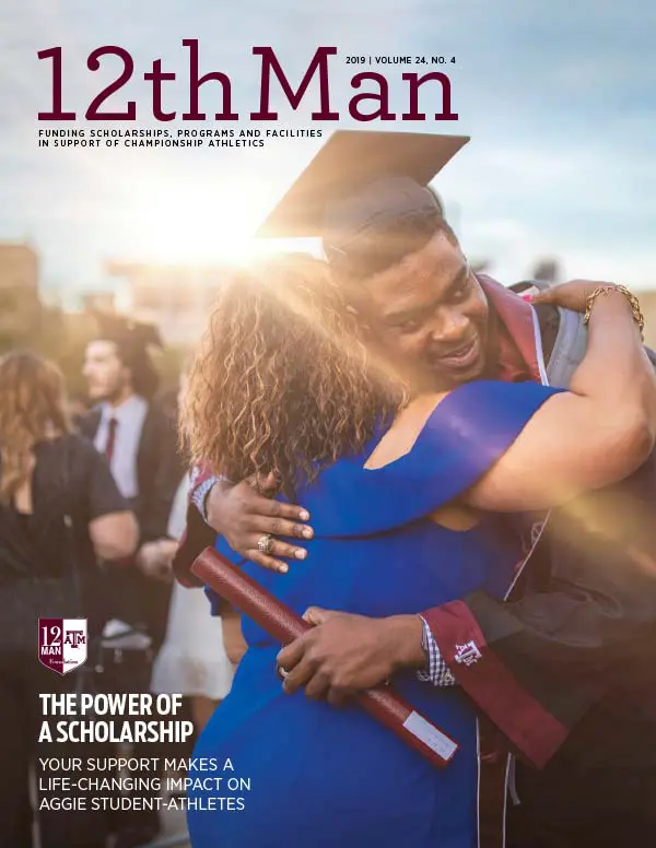 Student in graduation gown giving a woman a hug