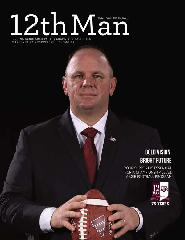 A man in a suit holding a football