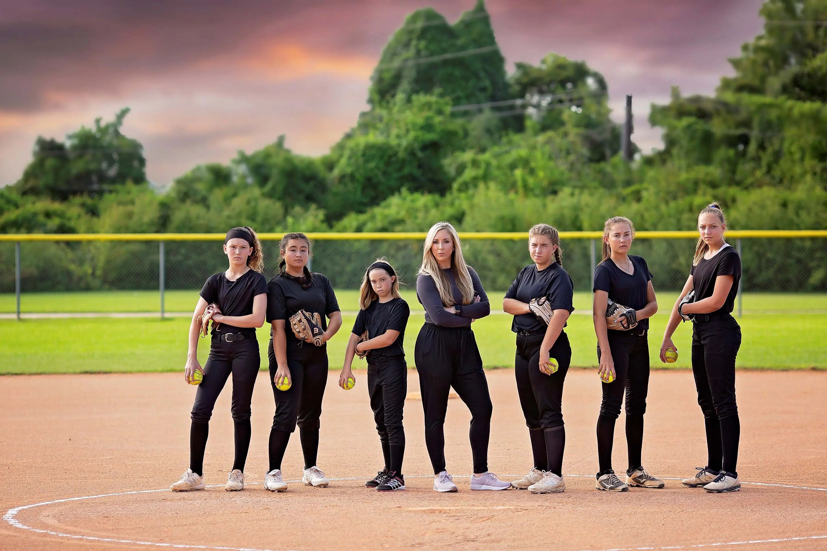 Amanda Scarborough and other softball players posing for photo on the softball field