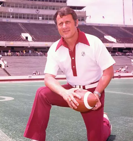 Emory Bellard posing with a football