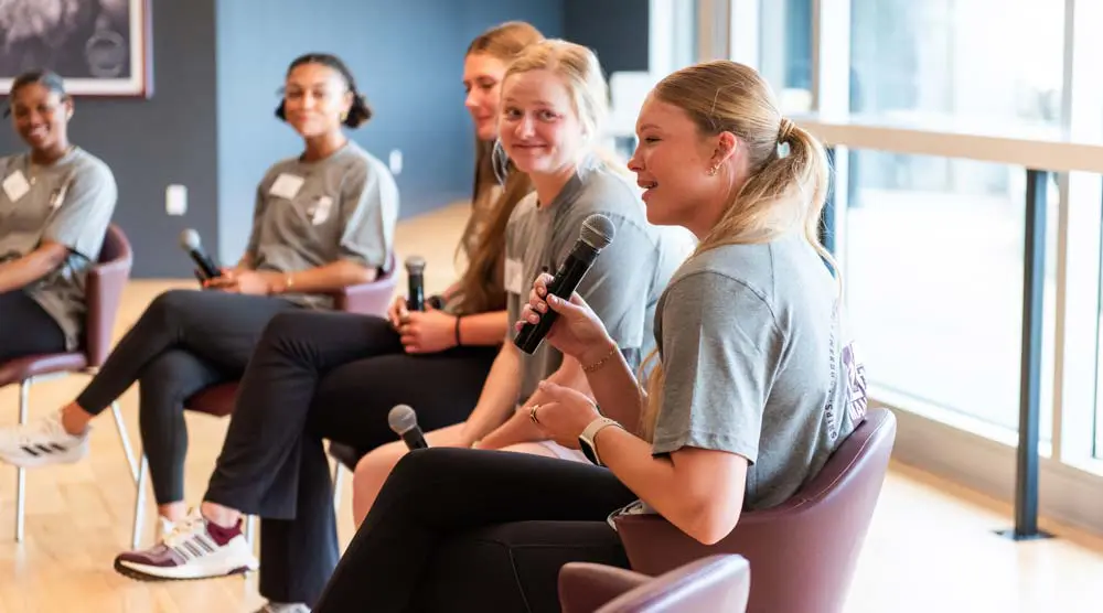 a group of women with microphones having a discussion