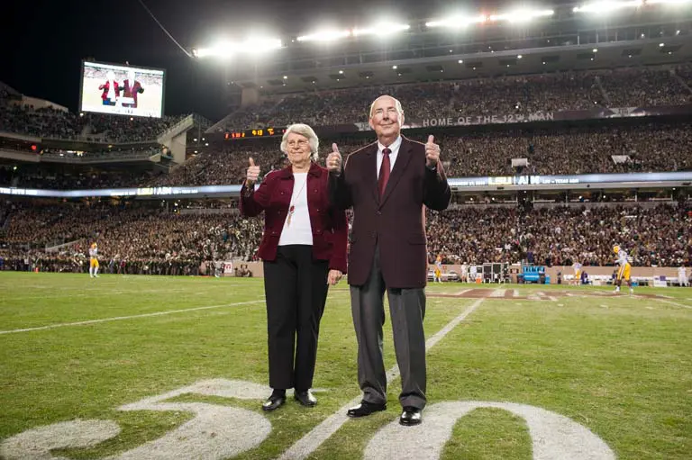 Alice and Erle Nye on the field giving thumbs up