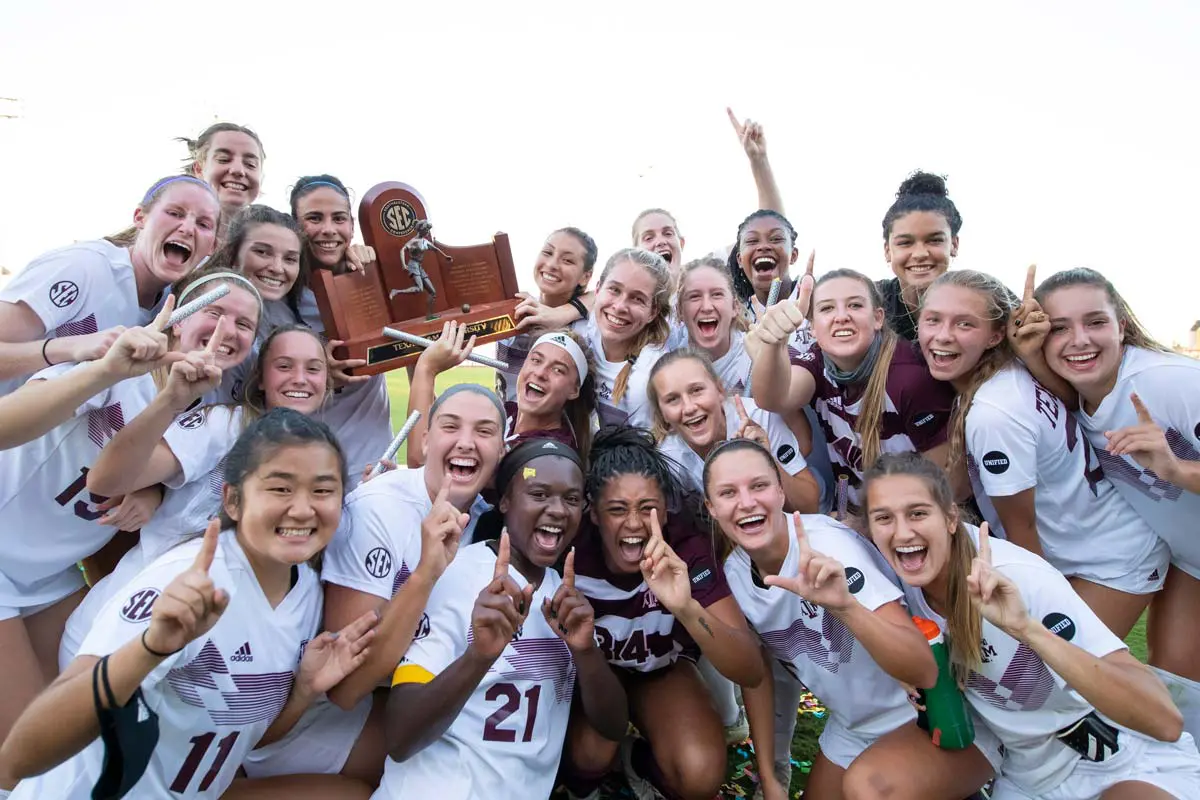 Women's soccer team posing with SEC trophy