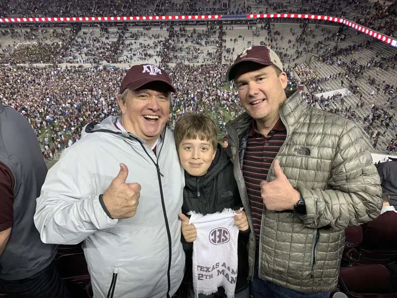 A family posing in the stands