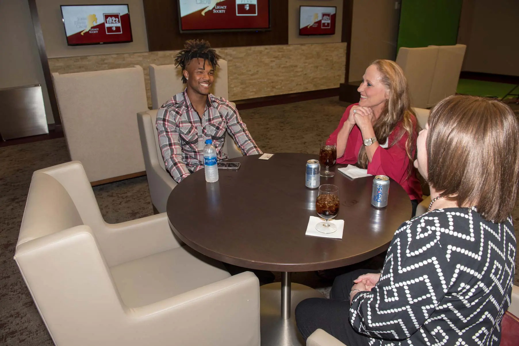 Camron Buckley sitting at a table with others