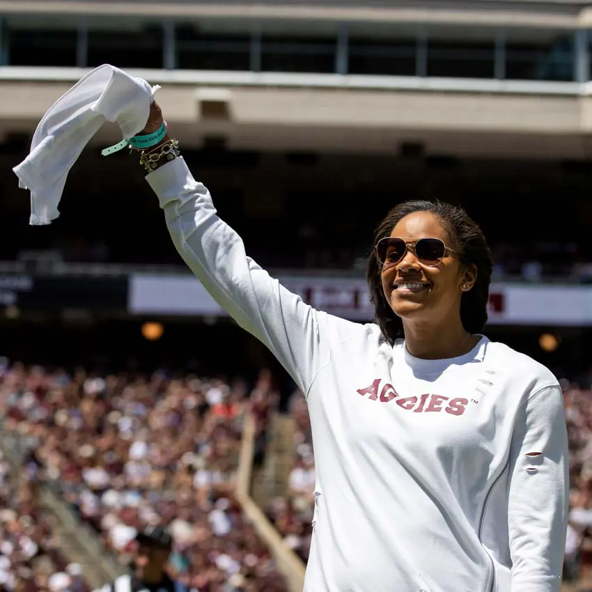 Joni Taylor waving a towel