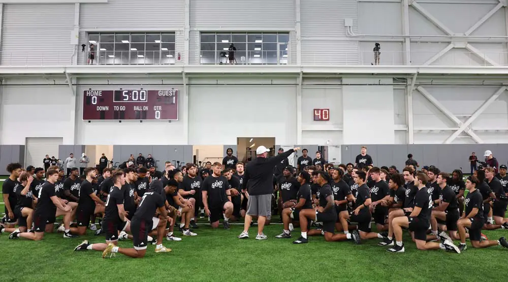 football team listening to coach