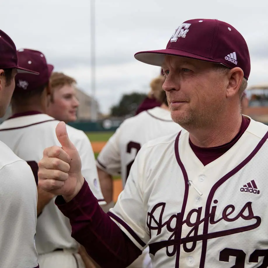 Jim Schlossnagle giving thumbs up to players on the field