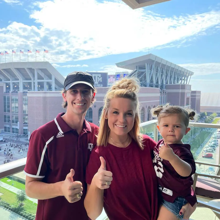 Abbey and Michael Pickel with their daughter at a football game