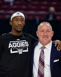 Student-athlete posing with coach