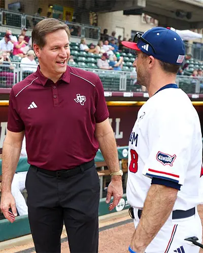 trev alberts talking to baseball player