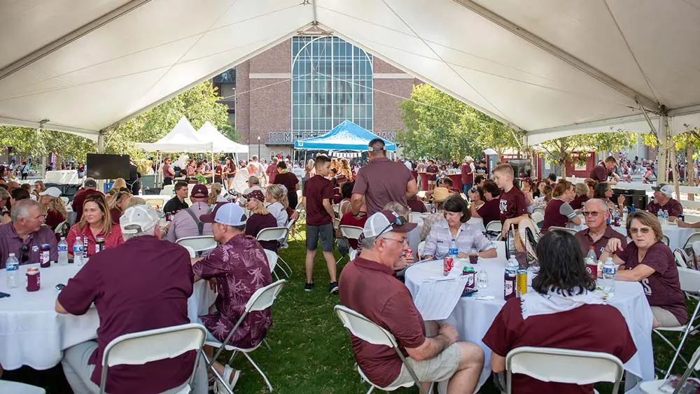 people eating under a tent