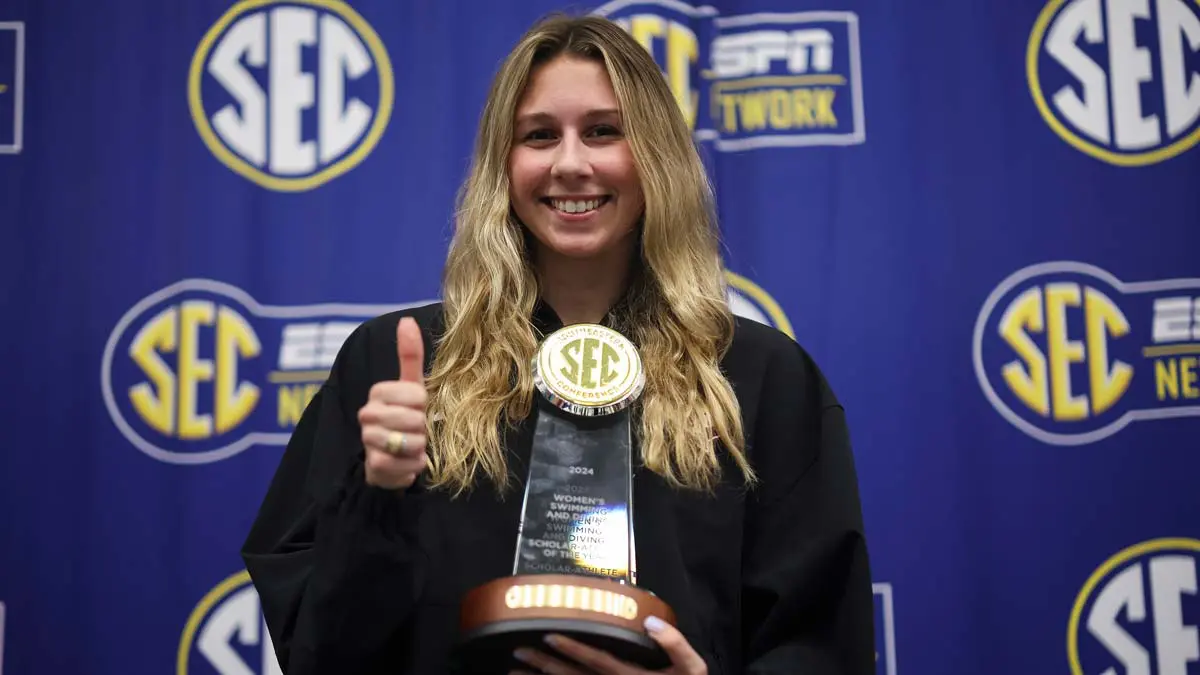 Student-athlete holding trophy