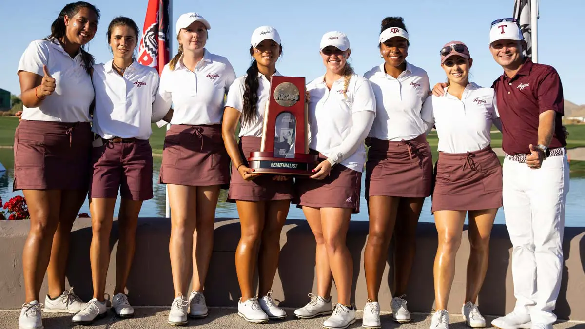 Student-athletes posing with trophy