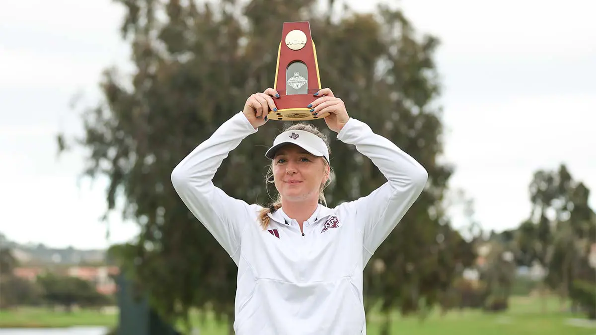 Woman holding trophy above her head